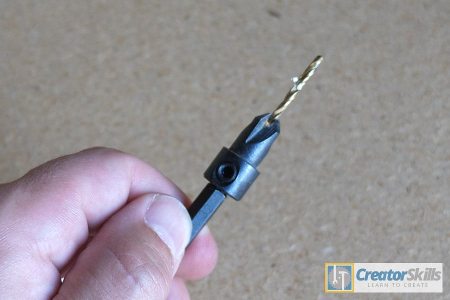 Countersinking drill bit being held on angle by hand large